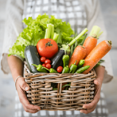 Jan 12, Healthy Eating for Your Family and the Planet: Person holding a wicker basket of fresh carrots, tomatoes, peppers, zucchini, and lettuce.