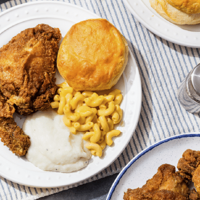 May 11, Potluck Luncheon: Plate of fried chicken, a biscuit, macaroni and cheese, and mashed potatoes.